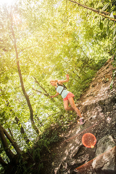 istock Female runner running downhill in a forest 502844074