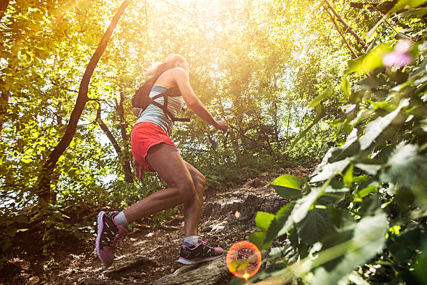 istock Woman running uphill on a rocky path 502844298