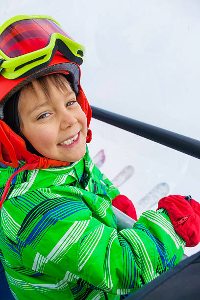 istock Little skier on ski lift 502845486