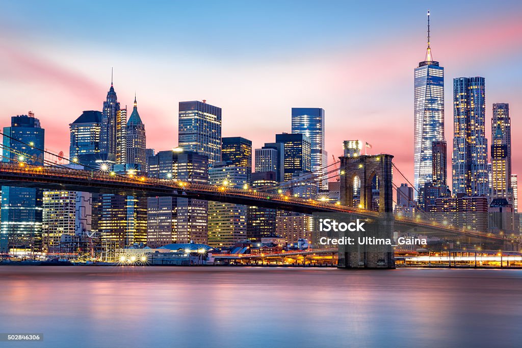 Lower Manhattan skyline Brooklyn Bridge at and the Lower Manhattan skyline under a purple sunset New York City Stock Photo