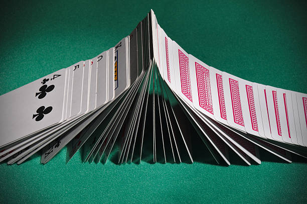 istock Poker playing cards turning face-up sequentially like dominoes 502846746