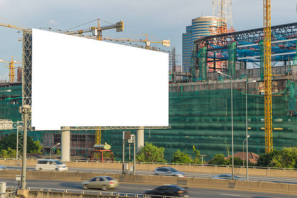 istock Blank billboard ready for new advertisement on road with Constru 502851808