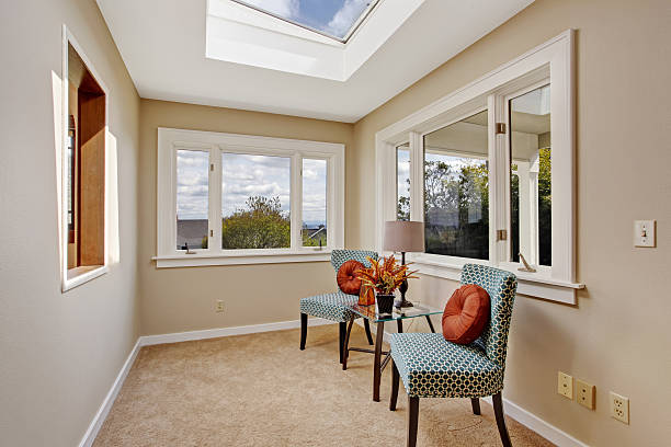 istock Small room with skylight and colorful chairs 502857691