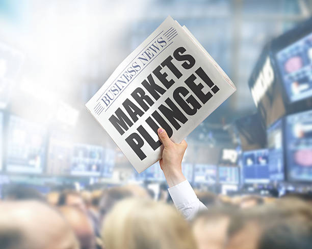 istock Holding Newspaper with Markets Plunge 502857893