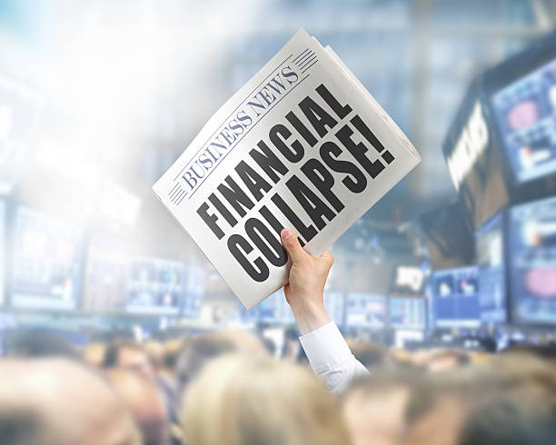 istock Holding Newspaper with Financial Collapse 502857959