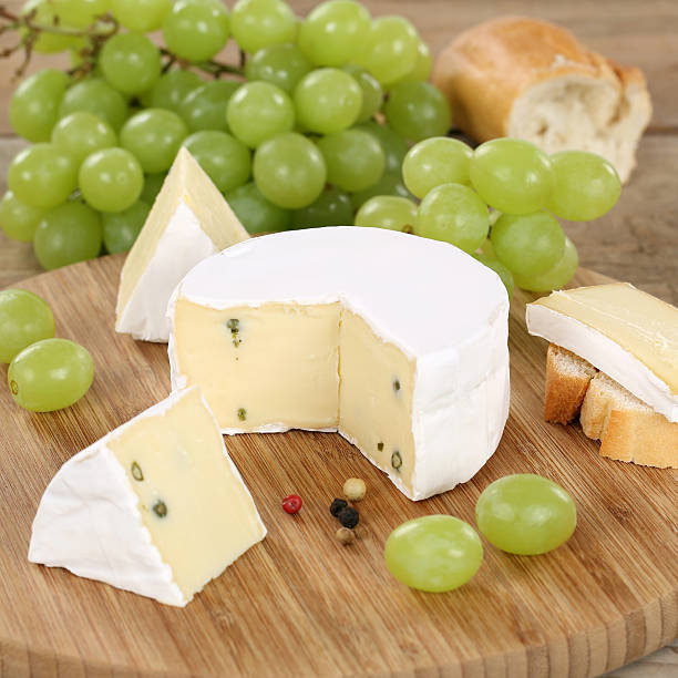 istock Soft cheese like Camembert or Brie with grapes 502858579