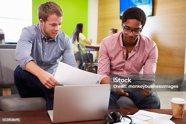 Creatives Having Informal Meeting On Sofas In Design Studio Stock Photo - Download Image Now