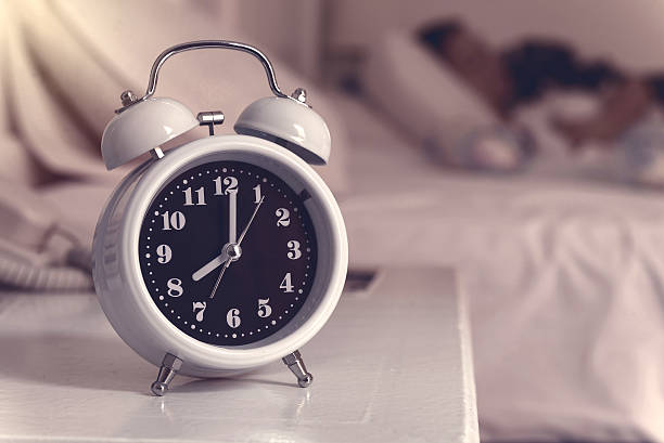 istock alarm clock on the bed in bedroom, retro style 502860662