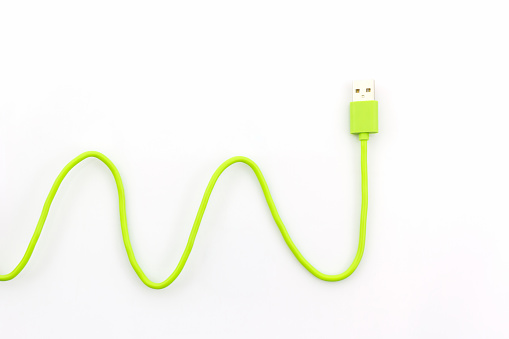 Green USB cable for smartphone on white background.