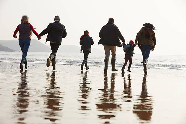 istock Multi Generation Family Walking On Winter Beach 502862241