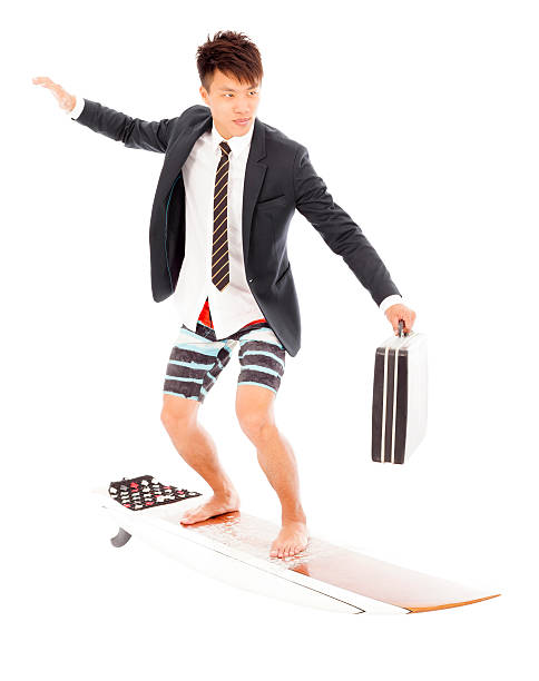 istock business man holding a briefcase and standing surfing board 502862861