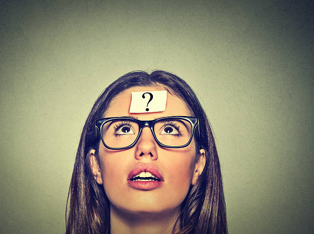 istock Thinking woman with question mark. Thoughtful girl looking up 502867700