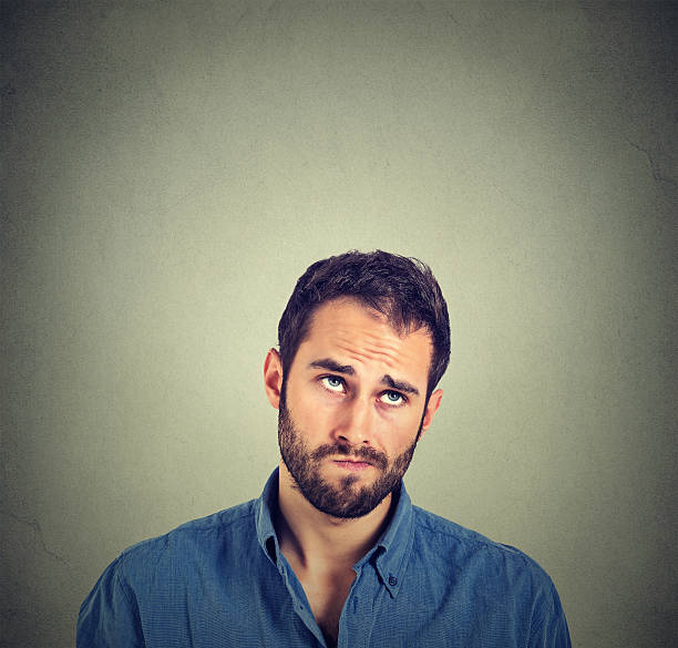 istock funny confused skeptical man thinking looking up 502869172