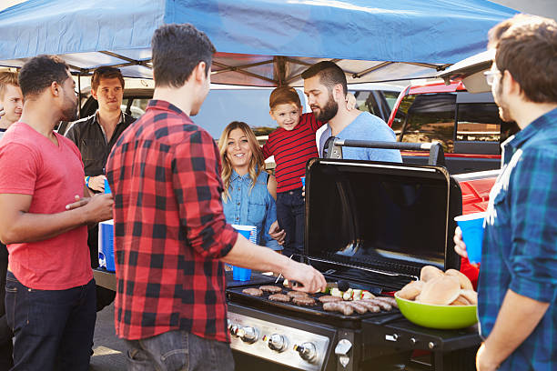 Group Of Sports Fans Tailgating In Stadium Car Park Group Of Sports Fans Tailgating In Stadium Car Park tailgate party photos stock pictures, royalty-free photos & images