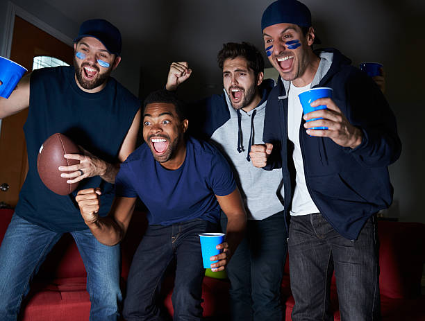 group of male sportfans vor dem spiel im fernsehen - sitting 20s adult american football stock-fotos und bilder