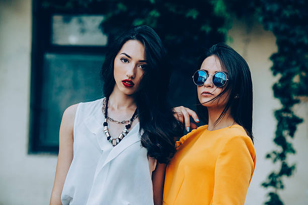 istock Two beautiful friends pose on white background 502873858