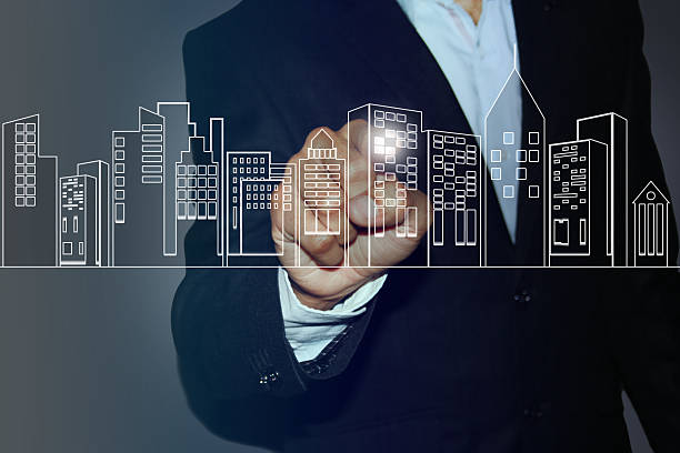 istock businessman touching high-tech image of building model 502875320