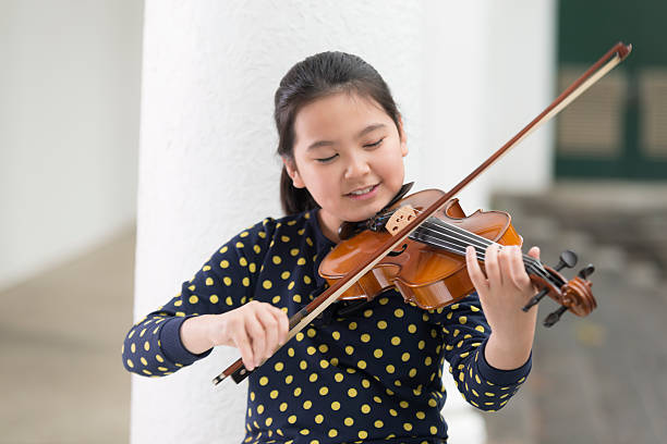 istock Frontal View, Cute Girl Playing Violin 502885312