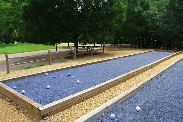 two beautiful blue bocce courts in a lush setting