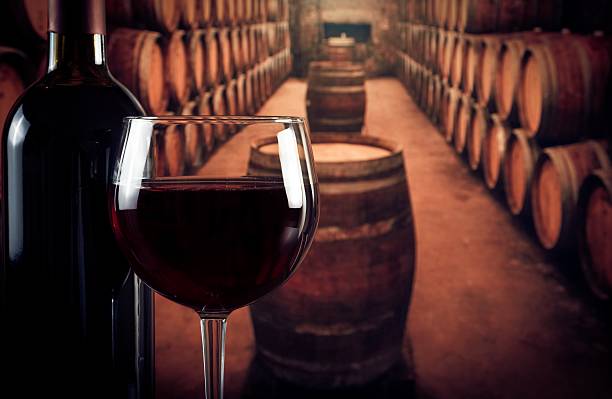 istock wine glass near bottle in old wine cellar 502886868