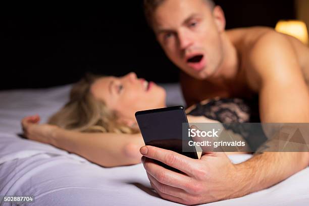Surprised Man Looking At His Phone Stock Photo - Download Image Now - Sex and Reproduction, Sexual Issues, Telephone
