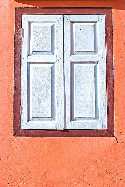 istock decorative white window on an old orange stucco wall 502889051