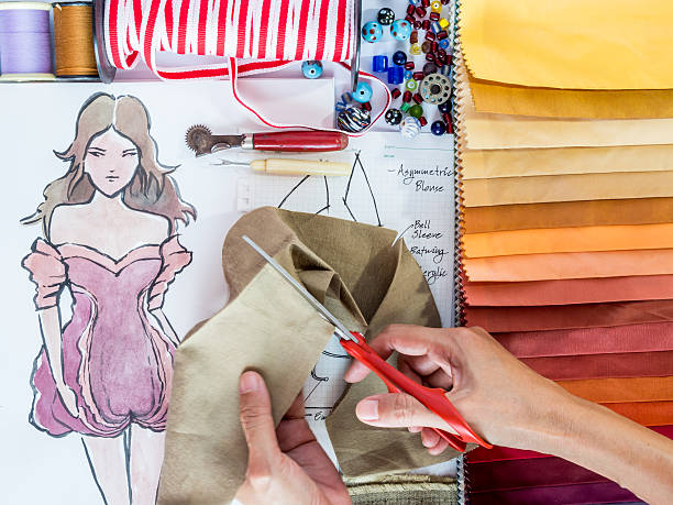 istock Fashion designer working with material and hand-drawn illustration 502890063