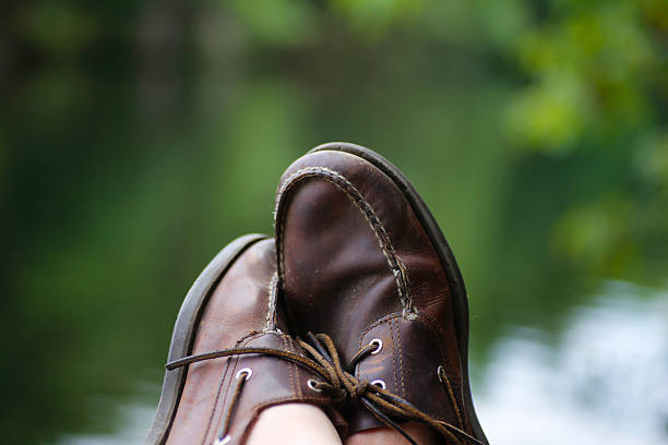 Leather shoes on a wood rail stock photo