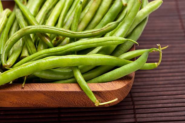 istock String Beans in a Wooden Bowl Close Up 502894480