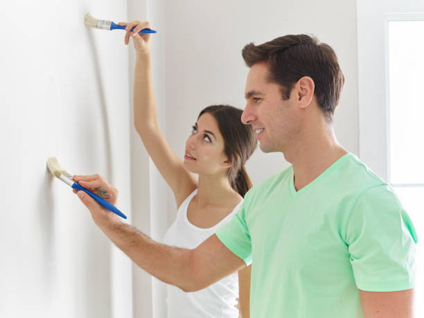 istock Couple painting wall 502895202