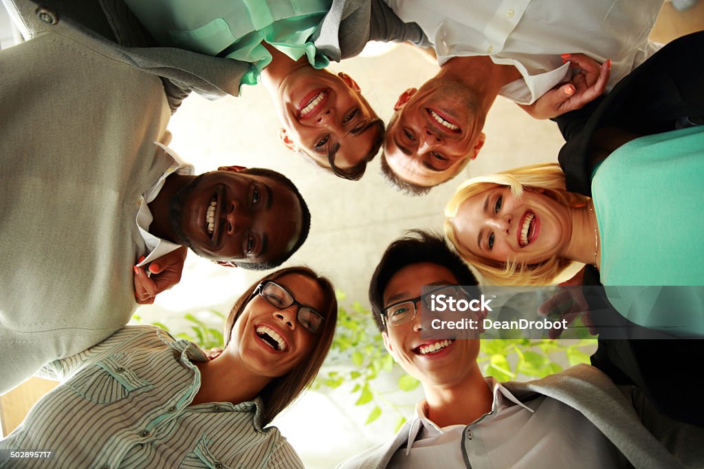group of businesspeople Happy business people with their heads together representing concept of ftiendship and teamwork Adult Stock Photo