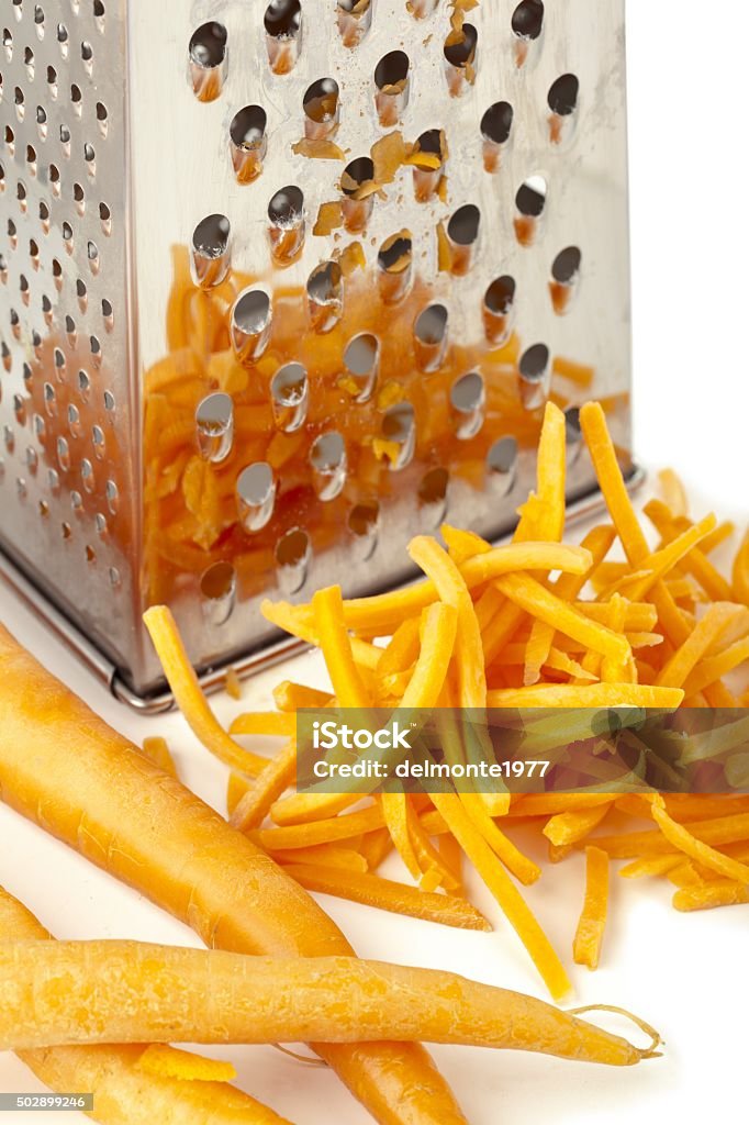 rub fresh carrots in the scraper 2015 Stock Photo