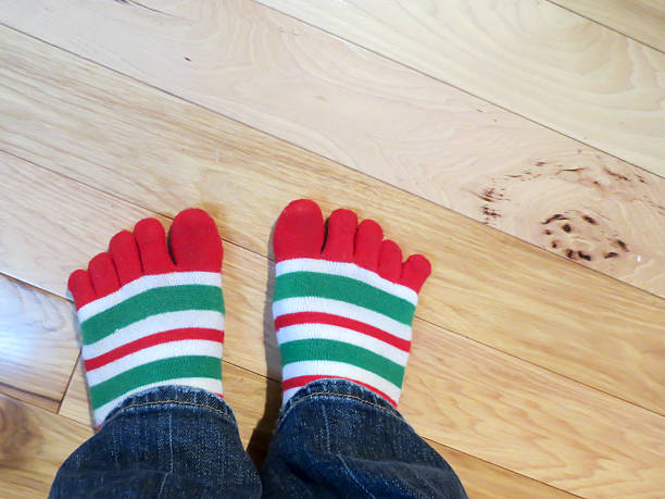 istock Festive striped socks with toes on wood 502899342