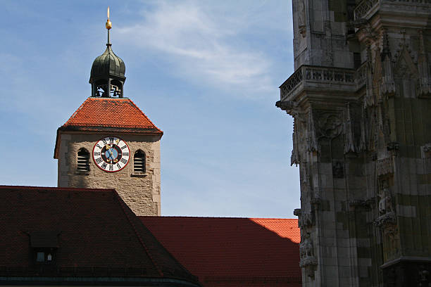 Regensburg, Germany - July 23, 2007: A clock tower looms over the medieval town of Regensburg, a cultural centre during the Middle Ages.