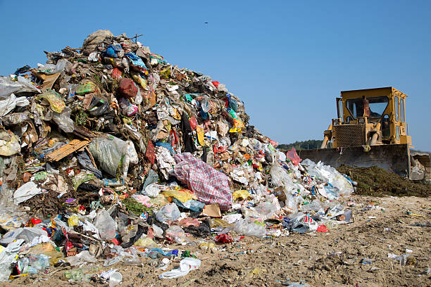 Bulldozer moving garbage in a landfill