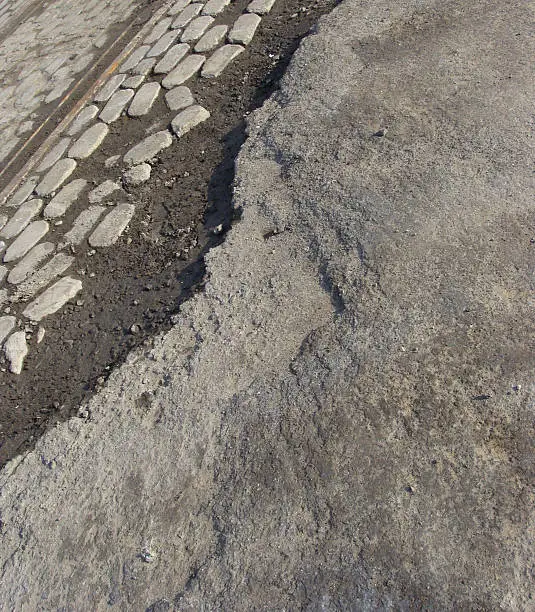 road with layers of asphalt,cobbles and tram-rails