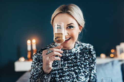 Beautiful woman celebrating new year with champagne