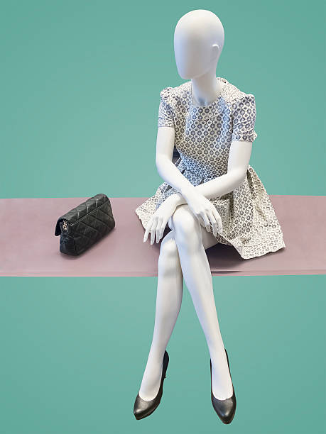 A woman in a summer dress sit on the bench