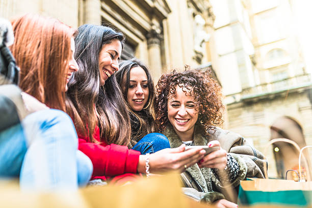 istock Young Friends Using Mobile Phone Together While Shopping 502912134