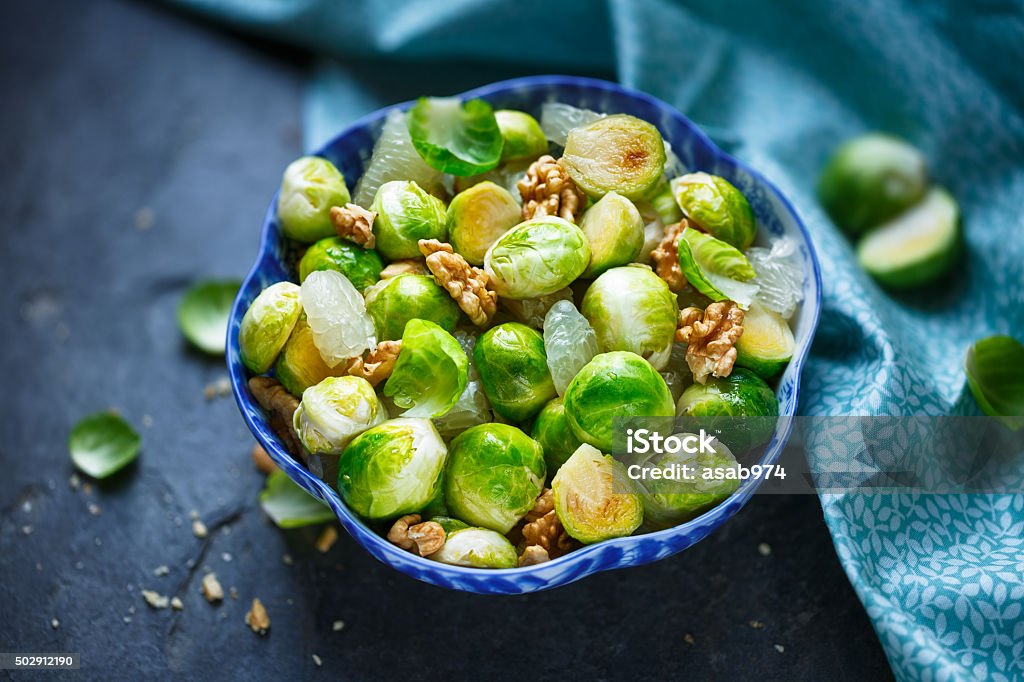 Brussels sprouts salad Brussels sprouts salad with honey, walnuts and pomelo. Brussels Sprout Stock Photo
