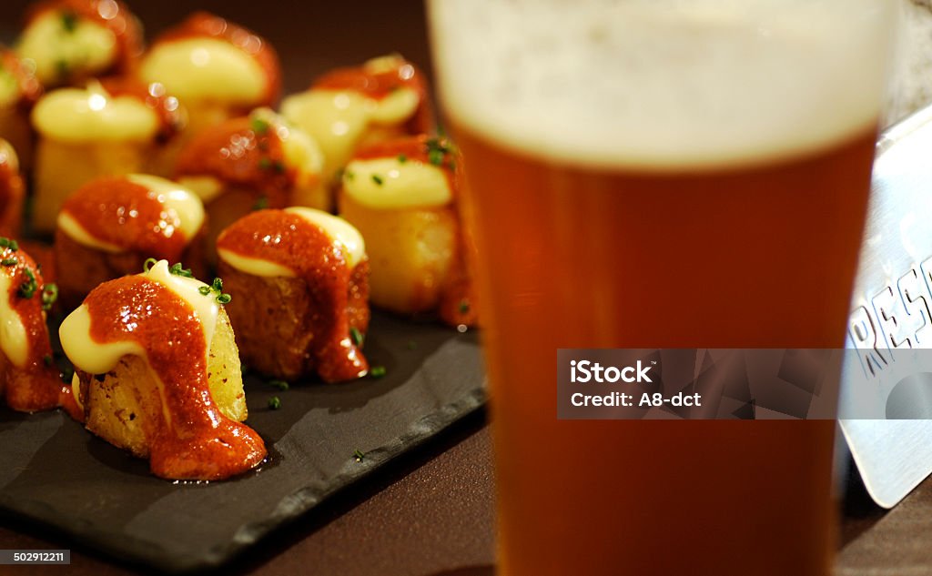spanish tapas and beer image of PATATA BRAVAS and beer in the spanish bar Spanish Food Stock Photo