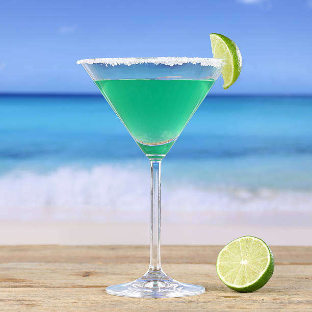 istock Green Martini cocktail drink on the beach 502912371