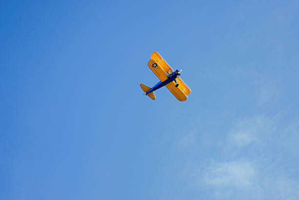 istock Biplane aircraft flying overhead in sky 502913530