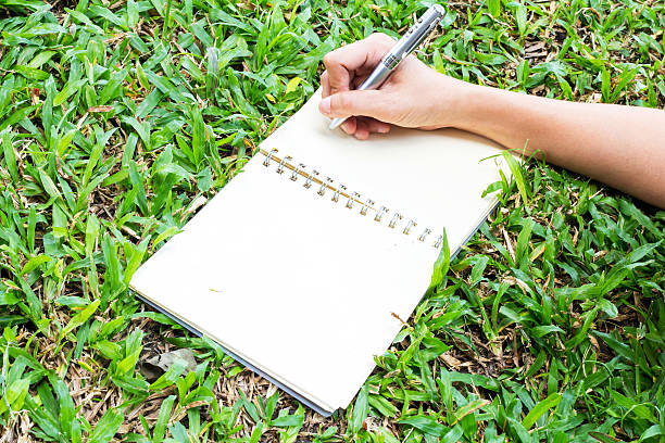 istock notebook paper  with pencil in hand 502913944