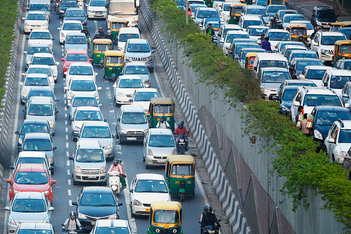 Busy highway packed full of vehicles in Delhi, India.