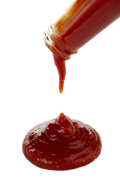pouring ketchup stock photo