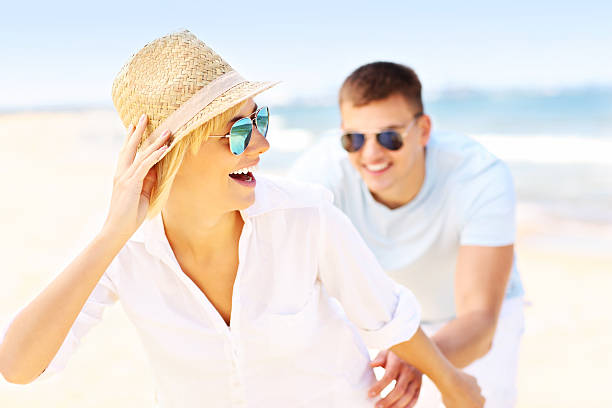 istock Happy man chasing a woman at the beach 502916002