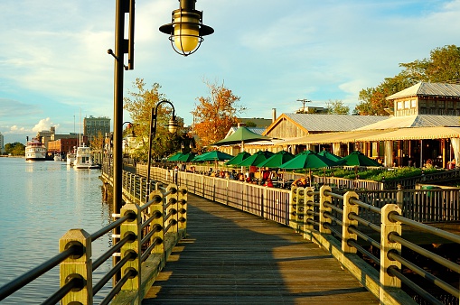 Wilmington, NC  USA - September 21, 2011: Boardwalk along the shore with restaurants and boats