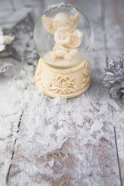 Christmas angel statuette on silver background