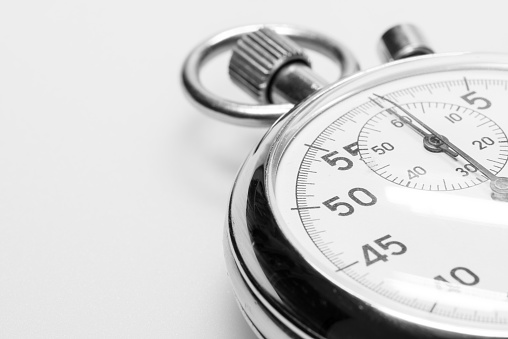 Close-up of a man's hand holding a pocket watch in monochrome
